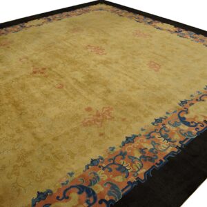 Golden yellow rug featuring a dark outer border and blue, peach, and coral scrolling motifs.