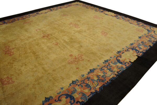 Golden yellow rug featuring a dark outer border and blue, peach, and coral scrolling motifs.