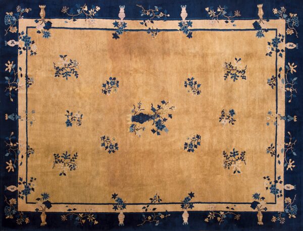 Ochre field rug with a dark blue border accented by floral vases and scattered blue and cream bouquets.