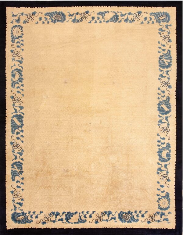 Beige low-pile rug featuring subtle geometric patterning and a thick border of blue floral and cloud designs.