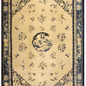 Light beige rug with dark blue floral patterns, a central motif, and complex multi-layered borders.