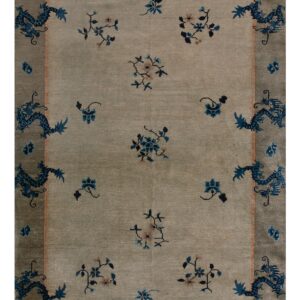 Light tan rug with blue floral sprays and a darker gray border featuring stylized blue dragon patterns.