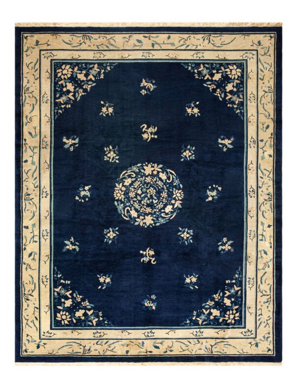 Dark blue rug featuring an intricate cream and teal floral pattern, central medallion, and wide border.