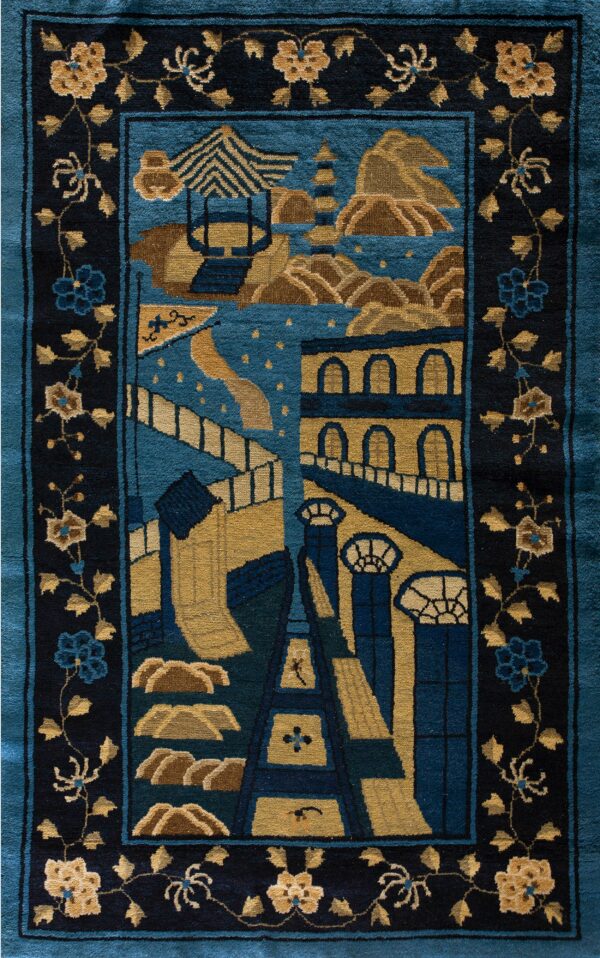 Teal and gold pictorial rug showing architectural elements and mountains, framed by a dark navy floral vine border.
