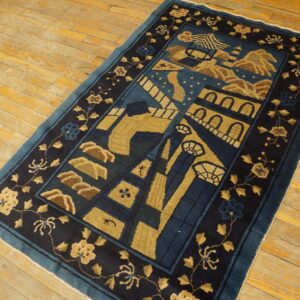 A dark blue and gold stylized rug featuring architectural patterns rests on rustic yellow wood plank flooring.
