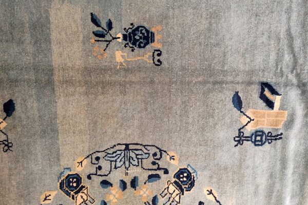 Light blue textured rug featuring stylized designs in navy, light blue, and beige colors.