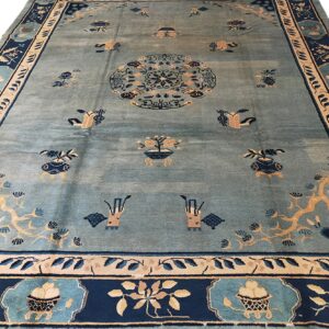 Light blue rug with an Oriental central medallion and scattered motifs in dark navy and tan.