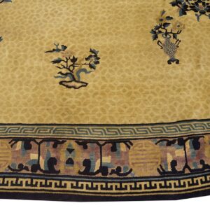 Tan rug with stylized floral motifs, a faint field pattern, and a wide blue and gold geometric border.