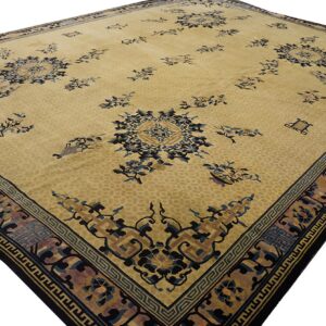 Angled view of a pale gold rug with stylized blue and brown floral patterns and complex geometric borders.