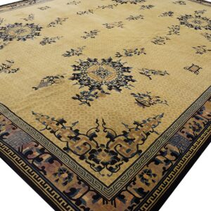 A low-pile yellow rug featuring scattered blue floral designs and detailed geometric-style borders.