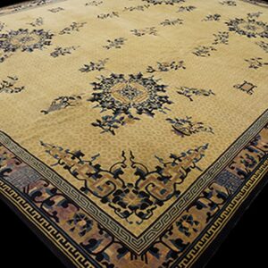 Beige rug featuring scattered dark blue medallions and an ornate multi-color geometric border.