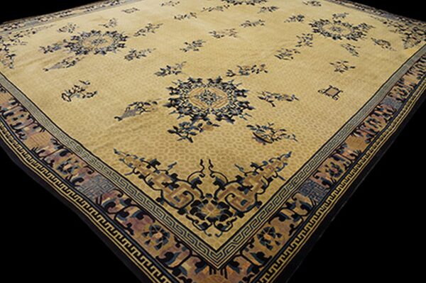 Beige rug featuring scattered dark blue medallions and an ornate multi-color geometric border.