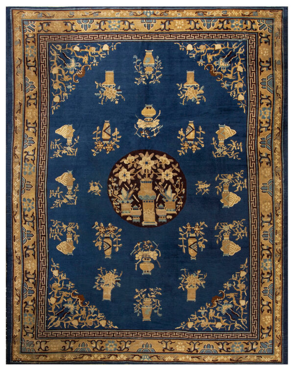Deep blue rug with tan and gold motifs of vases and flowers, featuring a prominent circular central design.
