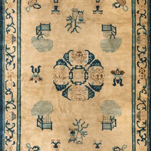 Light brown rug with blue and teal symbolic designs, framed by a thick dark blue scrolling border.