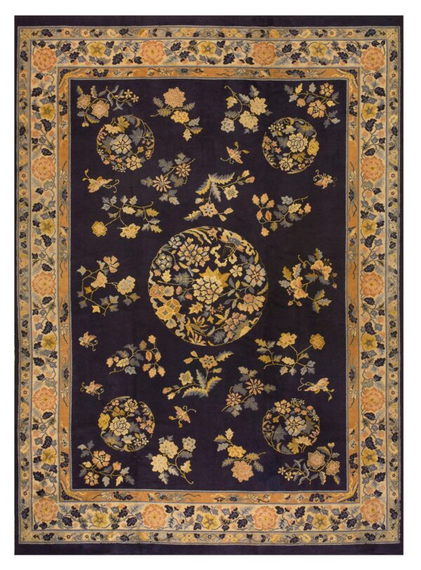 Dark navy rug featuring scattered yellow and peach floral sprays and medallions, framed by an intricate bordered design.