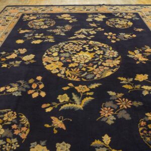 Dark blue rug featuring ornate yellow and peach floral medallions on wide wood planks.