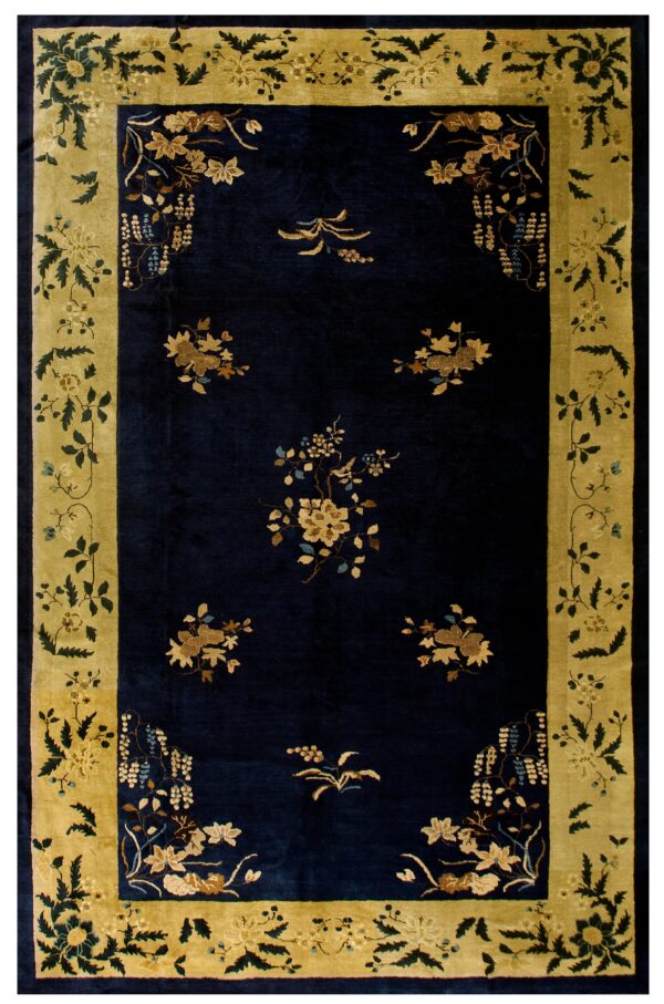 Plush navy rug featuring scattered gold flowers and an elaborate moss green and yellow border.