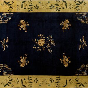 High-contrast rug with a dark navy field and gold floral sprays, framed by a broad yellow-green border.