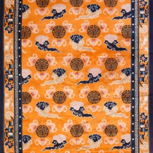 Orange field rug featuring stylized pink, navy, and cream cloud patterns and dark geometric medallions inside a navy border.