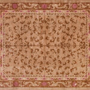 Tan and brown rug featuring stylized cloud patterns in the field and a border with pink flowers and scrolling dragons.