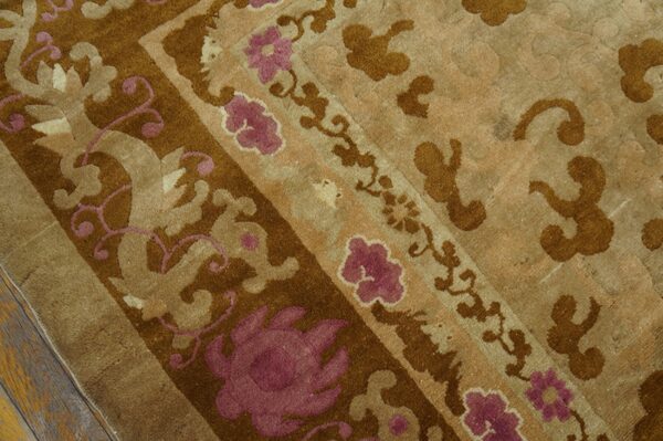 Close-up showing a high-pile rug patterned in brown, tan, and mauve floral designs on wood flooring.
