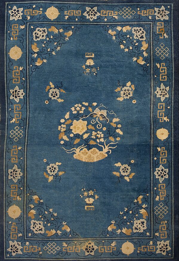 Textured deep blue rug with a tan floral medallion and highly detailed geometric borders.