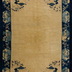 Traditional rug with a solid tan field and a wide navy blue border featuring architectural and floral motifs.