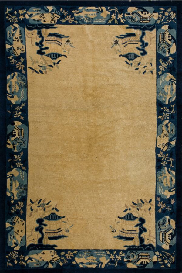 Traditional rug with a solid tan field and a wide navy blue border featuring architectural and floral motifs.
