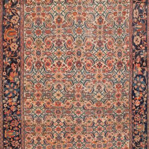 An intricate low-pile rug featuring a cream field, coral and teal motifs, and a wide dark blue floral border.