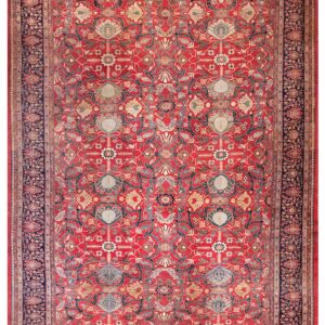 Detailed traditional rug featuring a red ground, repeating floral motifs, and wide navy border.