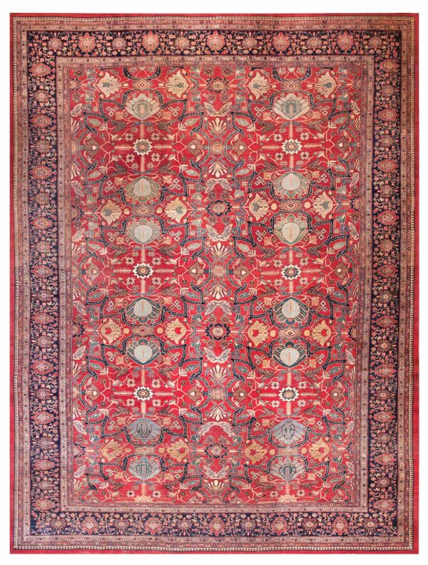 Detailed traditional rug featuring a red ground, repeating floral motifs, and wide navy border.