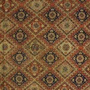 Muted rug with a repeating lattice of diamond medallions in rust, deep blue, and olive green.