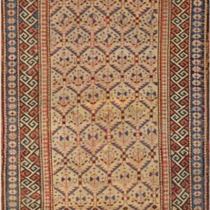 Geometric rug featuring a beige field with repetitive blue and red stylized motifs and multiple ornate borders.