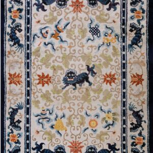 Cream field rug patterned with navy mythical animals, rust flowers, green vines, and framed by a dark blue border.