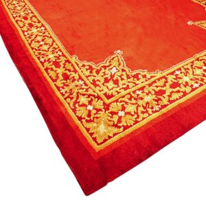 Close-up corner view of a red rug with a gold and yellow decorative scrolling border.