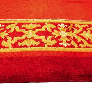 Detail of a vibrant red rug featuring a gold, yellow, and white decorative patterned band.