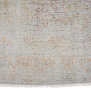 Low-pile rug section showing light gray, faded orange, and purple distressed traditional patterns and fringe.