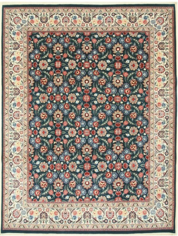 Deep indigo rug with intricate floral patterns in red, pale blue, green, and a wide cream medallion border.
