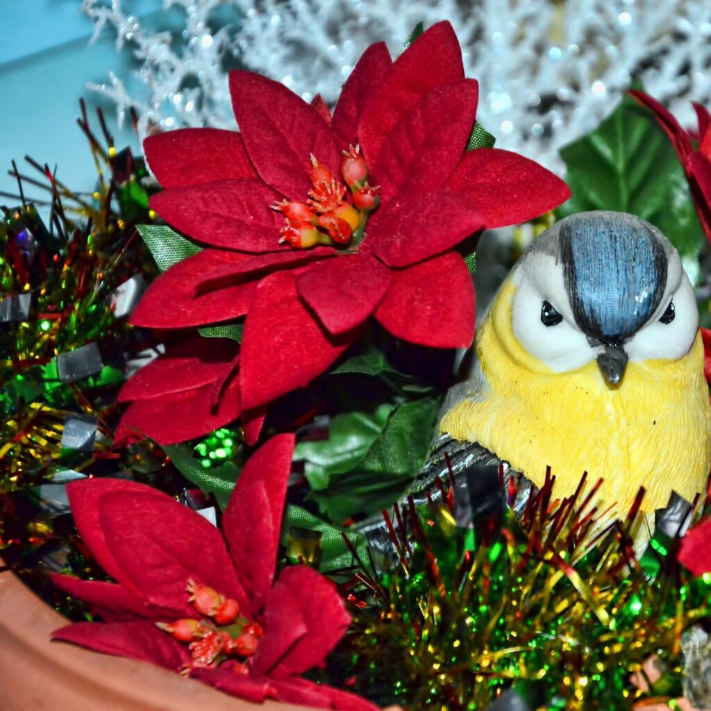 Bird figurine among festive flowers