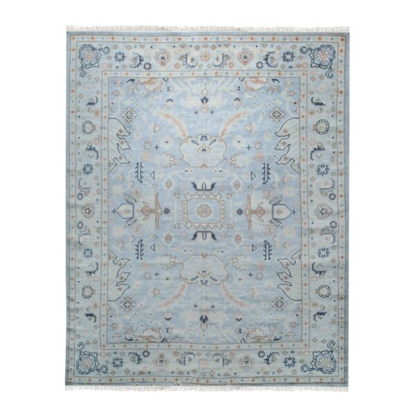 Traditional light blue rug featuring an ornate central medallion and detailed border in cream, tan, and navy.