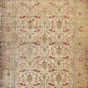 Distressed beige rug featuring an ornate faded floral pattern in magenta, gold, and teal.
