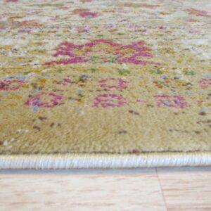 Textured beige rug with bright pink and multi-color patterns resting on light wood plank flooring.