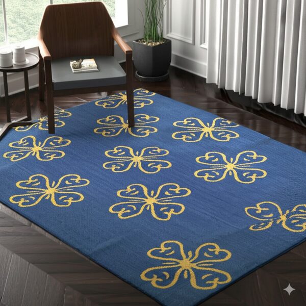 A blue rug with repeating yellow stylized butterfly patterns covers dark chevron wood flooring.
