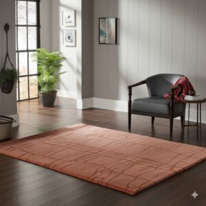 A rust-toned rug with an abstract linear pattern accents a room with dark floors and a gray armchair.