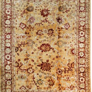 Traditional rug with an ochre field, intricate floral designs, and prominent red and cream borders.