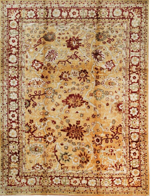 Traditional rug with an ochre field, intricate floral designs, and prominent red and cream borders.