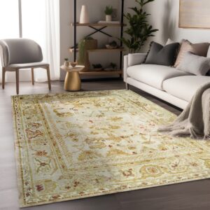 Beige rug with gold and red traditional patterns lies beneath a white sofa and grey accent chair.