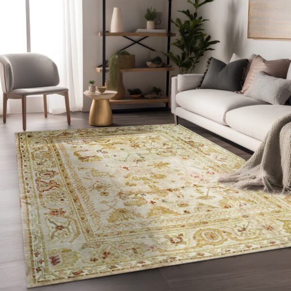 Beige rug with gold and red traditional patterns lies beneath a white sofa and grey accent chair.