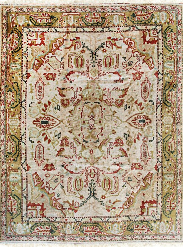 Traditional rug with a pale cream field, detailed red, green, and golden ornate patterns, and fringes.