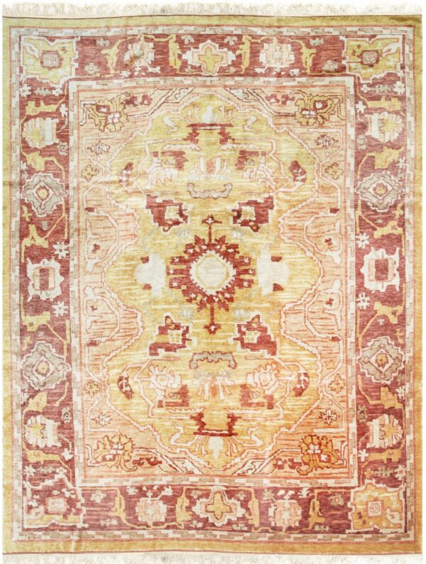 Gold and rust colored traditional rug with a central medallion and contrasting wide borders.